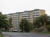 Tre av husen ligger längs Badvädersgatan utan några definerade rum runtomkring, annat än parkeringar.