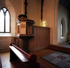 Predikstolen sammanbyggd med ett skrank som tidigare stod i koret.