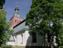 Kristina kyrka, exteriör. Långhus med koret i öst i förgrunden samt ses västtornet.