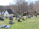 Rådmansö kyrkogård med Ridderstads putsade gravkapell från år 1747 
samt den knuttimrade stigluckan från 1770-talet. Ett ankare skänkt till församlingen 
år 1966 är uppställt på platsen för det gamla kapellets ingång.

