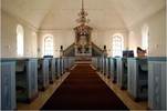 Det högvälvda och enkla kyrkorummet domineras av den pampiga altarpredikstolen
