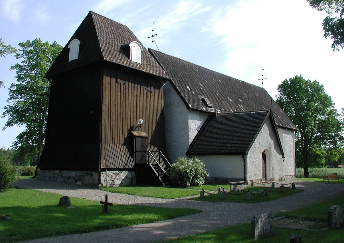 Säby kyrka samt klockstapeln intill den västra gaveln, sett från sydväst.