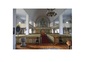 Vy över kyrkorummet mot orgelläktaren och de stora märkligt välbevarade sidoläktarna. 