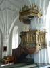 Den äldsta predikstolen skänkt av Karin Trast (som även skänkte predikstol till Bygdeå församling 1658) finns inte bevarad annat än i form av ett par skulpturer som suttit på speglarna. Nuvarande predikstolen i renässansstil uppsattes i kyrkan 1756 och kommer från Munktorps församling i Västmanland. Den ska ha tillverkats 1623–24 och anses vara en av de bästa representanterna för snidare Hans Rabéns tidiga predikstolar. 1842 försågs den med utbuktande underrede vilket förändrade karaktären. Bemålningen från 1930-talet bygger på den ursprungliga färgbehandlingen som övermålades med gråvit oljefärg 1842.