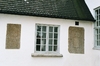 Rackeby kyrka. Fönster och inmurade gravhällar i västfasaden. Neg.nr 03/119:11