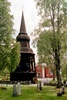 Hällesjö kyrka med omgivande kyrkogård och klockstapel. 