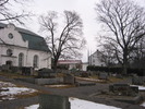 Säbrå kyrka med omgivande kyrkogård, vy från sydväst. 