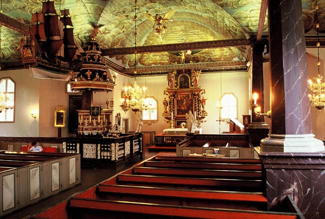 Interiören mot öster, en praktfull och genuin barockmiljö från 1600-talets slut. Flera av de kända konsthantverkarna vid denna tid har bidragit med arbetena i kyrkan. 
