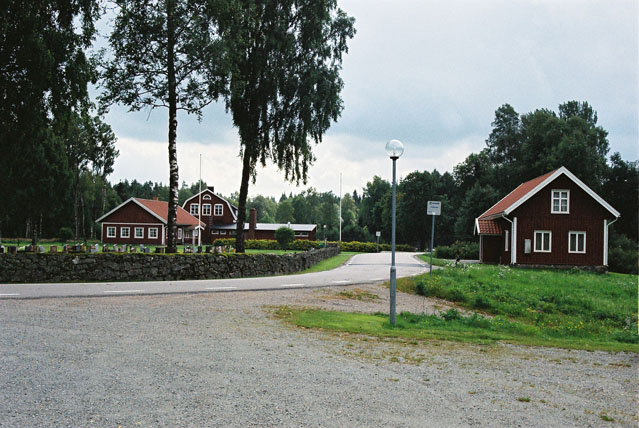 Miljön vid Töftedals kyrka med den fd skolan/sockenstugan närmast till höger. Till vänster syns församlingshemmet och bakom detta ytterliggare en f d skolbyggnad. Foto från kyrkan i norr.

