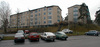SAK01247
Stockholm, Sätra, Hållsätra 8, Hållsätrabacken 9-27 ext från parkeringen fr.norr.

Vy över bostadshusen från parkeringsplatsen i norr. Notera trappan upp i slänten till gården. 

