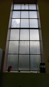 Järnfönstren är rektangulära, höga och spröjsade.