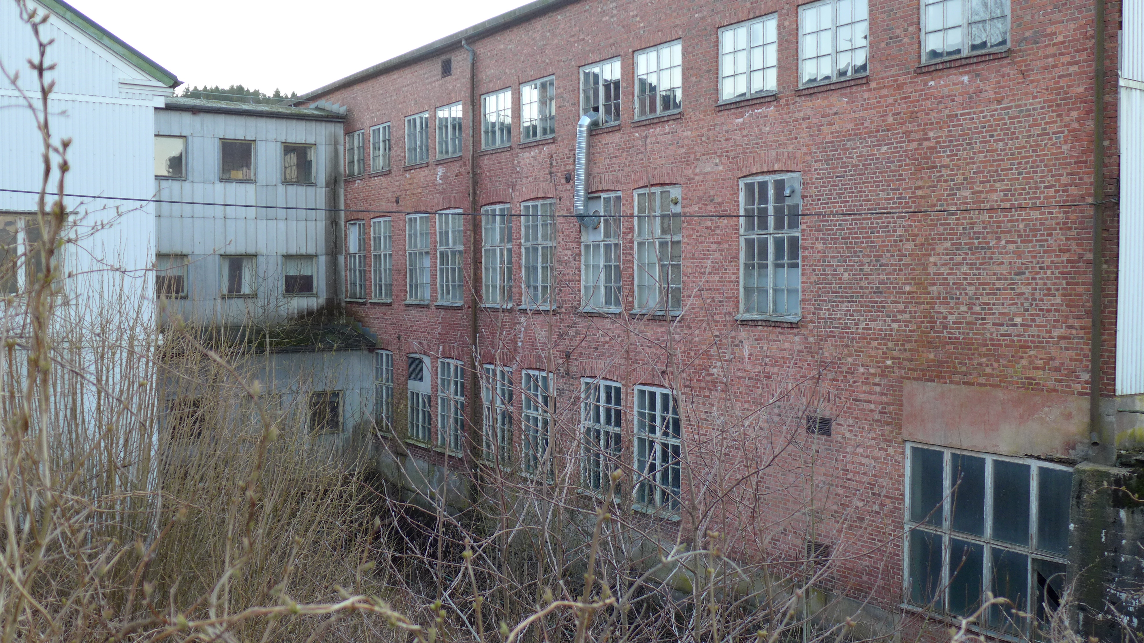 Kraftverket Stigen mellan är inrymt i en lokal inne i Stigens textilindustribyggnader. Bakom fönstret längst ner till höger finns kraftverkets maskinhall. Anläggningen är inte i drift.

