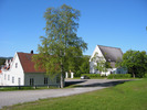 Skogs kyrka med omgivande kyrkogård & kyrkoområde. Vy från nord öst. 
